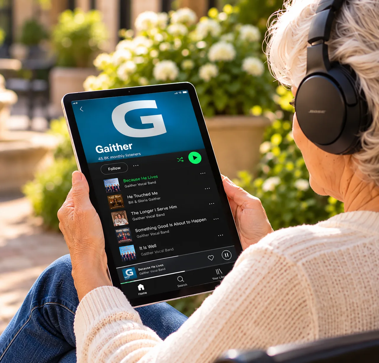 A woman listening to Gaither Music on a tablet.
